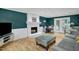 Cozy living room featuring a fireplace, hardwood floors, and access to a backyard at 2256 W Front St, Burlington, NC 27215