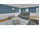 Comfortable living room with hardwood floors, wainscoting, and plush gray furniture at 2256 W Front St, Burlington, NC 27215