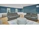 Comfortable living room with hardwood floors, wainscoting, and plush gray furniture at 2256 W Front St, Burlington, NC 27215