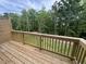 Wood back deck showing yard with wood fence and lush green trees and sky at 2313 Bay Minette Sta # 543, Apex, NC 27502