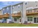 Townhome backyard with small wooden balconies and a well-maintained lawn at 2313 Bay Minette Sta # 543, Apex, NC 27502