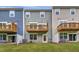 Townhome backyard with small wooden balconies and a well-maintained lawn at 2313 Bay Minette Sta # 543, Apex, NC 27502