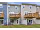 Townhome backyard with small wooden balconies and a well-maintained lawn at 2313 Bay Minette Sta # 543, Apex, NC 27502