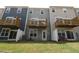 View of the backyard with sliding glass doors, wood balconies, and fenced in area at 2313 Bay Minette Sta # 543, Apex, NC 27502
