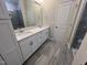 Bathroom with double sink vanity, white cabinets, tile floor, and separate shower stall at 2313 Bay Minette Sta # 543, Apex, NC 27502