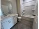 Bathroom with tiled floors, white cabinets, and tub shower at 2313 Bay Minette Sta # 543, Apex, NC 27502