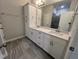 Bathroom features double sink vanity with white cabinets, tile floors, and separate shower at 2313 Bay Minette Sta # 543, Apex, NC 27502