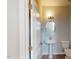 Stylish powder room with a pedestal sink, oval mirror, and modern lighting at 2313 Bay Minette Sta # 543, Apex, NC 27502