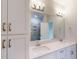 Bathroom featuring a double sink vanity, large mirror, and walk-in shower at 2313 Bay Minette Sta # 543, Apex, NC 27502