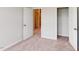A bright bedroom has neutral walls, plush carpeting, and an open closet at 2313 Bay Minette Sta # 543, Apex, NC 27502