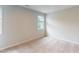 Neutral bedroom offers plush carpet, natural light, and a fresh clean aesthetic at 2313 Bay Minette Sta # 543, Apex, NC 27502