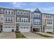 Three townhomes feature unique exterior designs, garage parking, and manicured front lawns for curb appeal at 2313 Bay Minette Sta # 543, Apex, NC 27502
