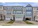 Townhome exterior showcasing colorful facades, attached garages, and landscaped front lawns offering inviting curb appeal at 2313 Bay Minette Sta # 543, Apex, NC 27502