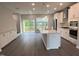 Bright, open kitchen with an island, stainless appliances, and sliding glass doors to the backyard at 2313 Bay Minette Sta # 543, Apex, NC 27502