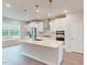 Modern kitchen features stainless steel appliances, a large island, and stylish pendant lighting at 2313 Bay Minette Sta # 543, Apex, NC 27502