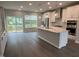 Bright, open kitchen featuring an island, modern light fixtures, and stainless steel appliances at 2313 Bay Minette Sta # 543, Apex, NC 27502