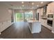 Bright, open kitchen with an island, stainless appliances, and sliding glass doors to the backyard at 2313 Bay Minette Sta # 543, Apex, NC 27502