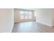 Spacious living room featuring stylish vinyl plank flooring, large windows offering ample natural light, and a serene atmosphere at 2313 Bay Minette Sta # 543, Apex, NC 27502