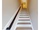 Bright stairway featuring wood handrail, leading to the upper level, showing modern design and construction at 2313 Bay Minette Sta # 543, Apex, NC 27502