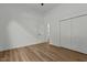 A bedroom with hard wood floors, closet doors and a door leading outside at 251 Sequoia Dr, Louisburg, NC 27549