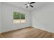 A bright bedroom with a ceiling fan and a view of the outdoors at 251 Sequoia Dr, Louisburg, NC 27549