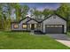 Charming single-Gathering home boasts a modern farmhouse style, complemented by a well-manicured lawn and beautiful twilight at 251 Sequoia Dr, Louisburg, NC 27549