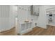 Bright laundry room featuring extra storage cabinets, shelving and neutral tones at 251 Sequoia Dr, Louisburg, NC 27549