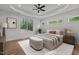 Bright main bedroom featuring hardwood floors, tray ceiling, and multiple windows offering natural light at 251 Sequoia Dr, Louisburg, NC 27549