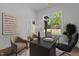 Modern office space with a sleek black desk, stylish chairs, and a window view at 251 Sequoia Dr, Louisburg, NC 27549