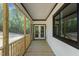 Long screened porch with light-colored wood and views of surrounding trees and yard at 251 Sequoia Dr, Louisburg, NC 27549