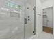 This stunning shower features marble tiling, a glass door, and a modern fixture at 251 Sequoia Dr, Louisburg, NC 27549