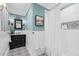 Bright bathroom features a black vanity with black and white tile floors at 2805 Chelsea Cir, Durham, NC 27707
