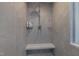 Walk-in shower includes stone-look tile and built-in bench at 2805 Chelsea Cir, Durham, NC 27707
