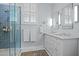 Bathroom featuring double sinks, white cabinets, walk-in shower and elegant fixtures at 2805 Chelsea Cir, Durham, NC 27707