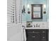 Powder bathroom showcasing a black vanity, wainscotting, and light blue walls at 2805 Chelsea Cir, Durham, NC 27707