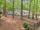 Lovely home with mature trees, a stream bed, and black metal fencing in a beautiful natural setting at 2805 Chelsea Cir, Durham, NC 27707