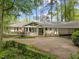 Expansive property featuring a home with a carport, a large front yard, and mature trees for privacy at 2805 Chelsea Cir, Durham, NC 27707