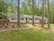 Charming ranch-style home with a stone pathway leading to the front door and lush landscaping at 2805 Chelsea Cir, Durham, NC 27707
