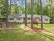 Charming ranch-style home with a stone pathway leading to the front door and lush landscaping at 2805 Chelsea Cir, Durham, NC 27707