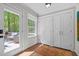 Bright hallway with closet, door to deck, hardwood floors, and a decorative area rug at 2805 Chelsea Cir, Durham, NC 27707