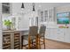 Modern kitchen featuring bar seating, stainless steel appliances, white cabinets and an island at 2805 Chelsea Cir, Durham, NC 27707