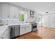 Modern kitchen features stainless steel appliances, white cabinets, farmhouse sink, and updated fixtures at 2805 Chelsea Cir, Durham, NC 27707
