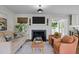 Inviting living room features a fireplace, comfortable seating, and an open layout to the kitchen at 2805 Chelsea Cir, Durham, NC 27707