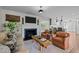 Open-concept living room featuring fireplace, TV, seating, and seamless flow into the modern kitchen at 2805 Chelsea Cir, Durham, NC 27707
