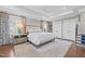 Spacious primary bedroom featuring a tray ceiling, hardwood floors, and custom curtains at 2805 Chelsea Cir, Durham, NC 27707