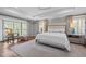 Spacious primary bedroom featuring a tray ceiling, hardwood floors, sitting area, and custom curtains at 2805 Chelsea Cir, Durham, NC 27707
