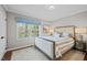 Bright bedroom featuring a patterned bedspread, two windows and a rug at 2805 Chelsea Cir, Durham, NC 27707