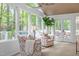Bright sunroom with lots of natural light, stylish chairs, and views of the lush outdoors at 2805 Chelsea Cir, Durham, NC 27707