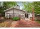 Exterior shot of home showcasing back deck, siding, chimney and mature landscaping at 2852 Rue Sans Famille, Raleigh, NC 27607