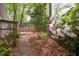 Idyllic backyard view showcasing a wooden deck, lush greenery, and colorful azaleas at 2852 Rue Sans Famille, Raleigh, NC 27607